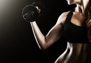 waist and belly with beads of sweat of young fitness woman