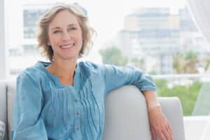 Happy woman relaxing on her couch at home